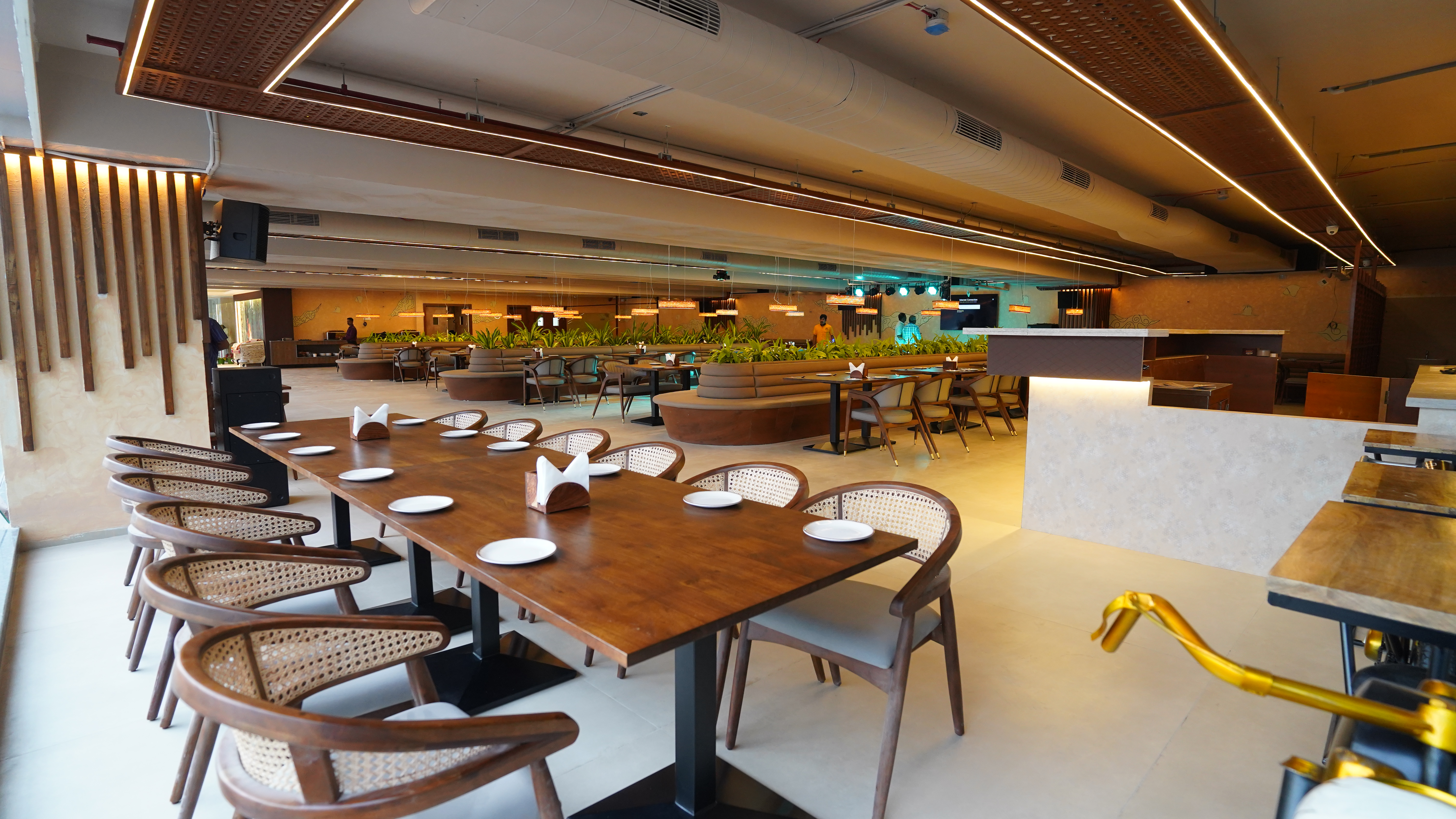 Bar area with high stools, warm lighting, and bottles of wine and spirits displayed