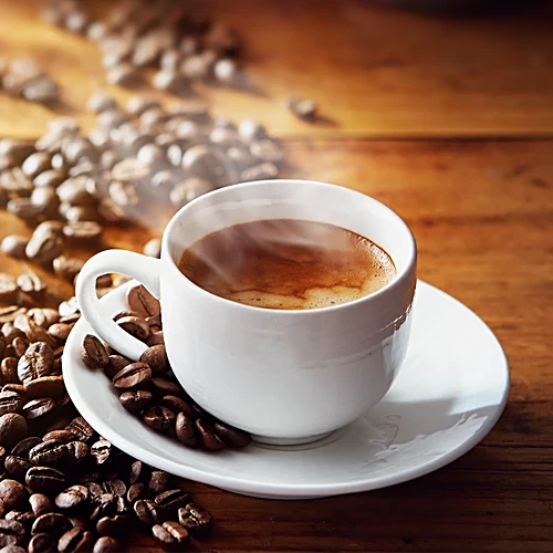 Cup of rich espresso coffee with crema on top served in a white ceramic cup