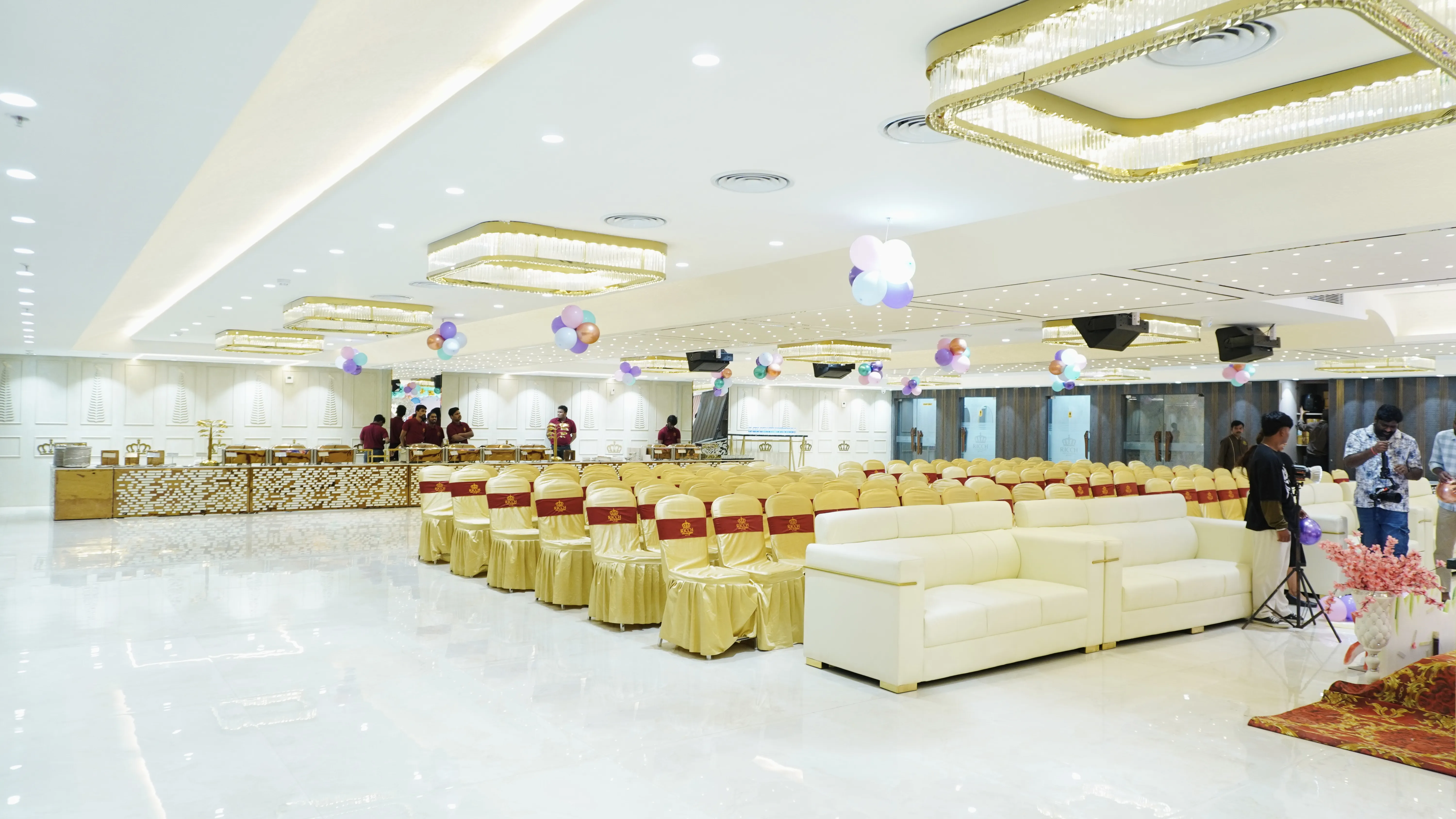 Horizontal image of a serene lake reflecting snow-capped mountains and pine trees