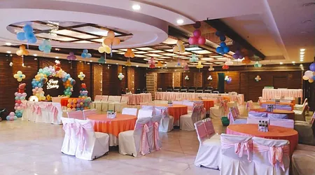 Birthday party with elegant table setup, floral centerpieces, and ambient lighting
