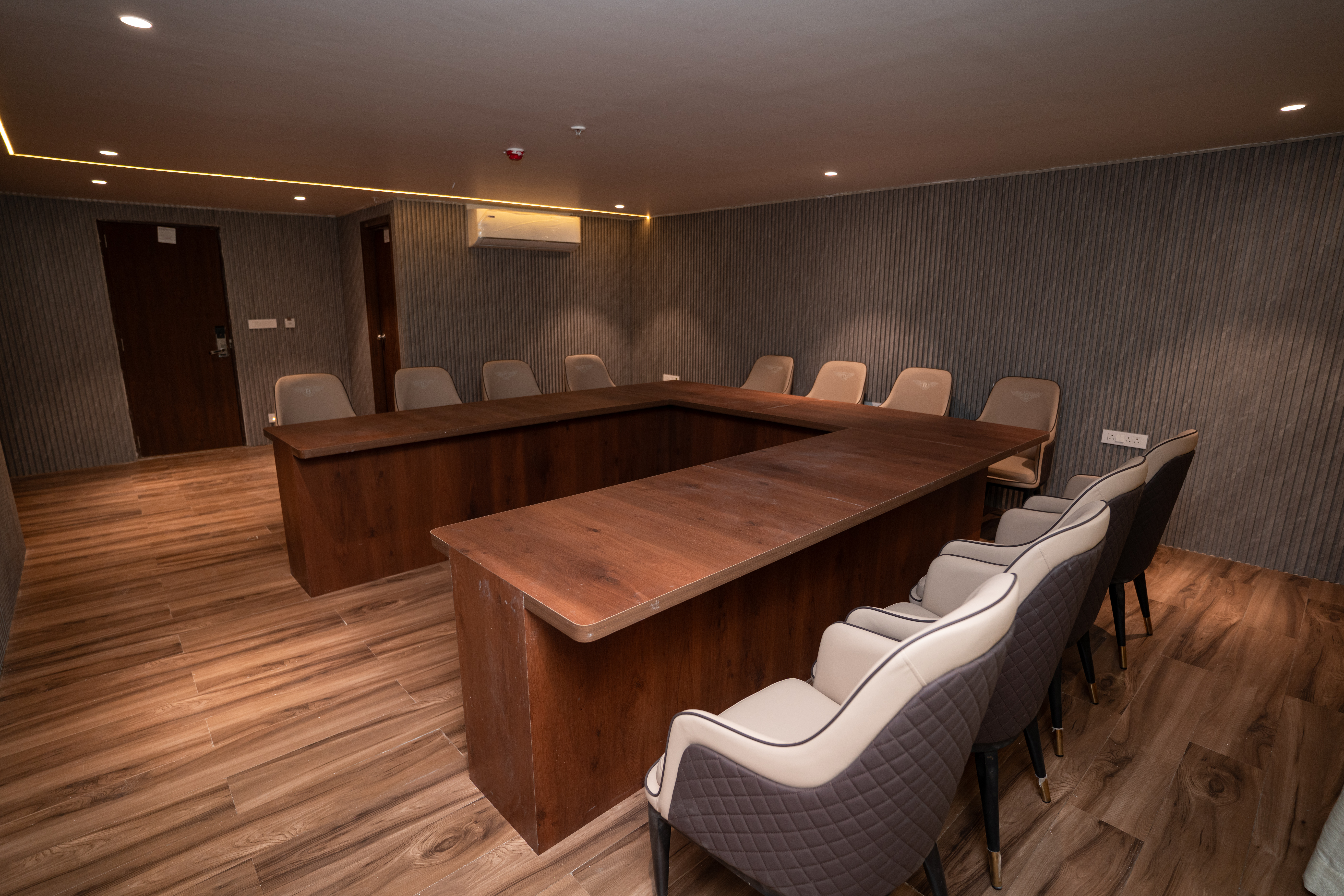 Corporate conference setup with large screen, stage, and elegant seating arrangement