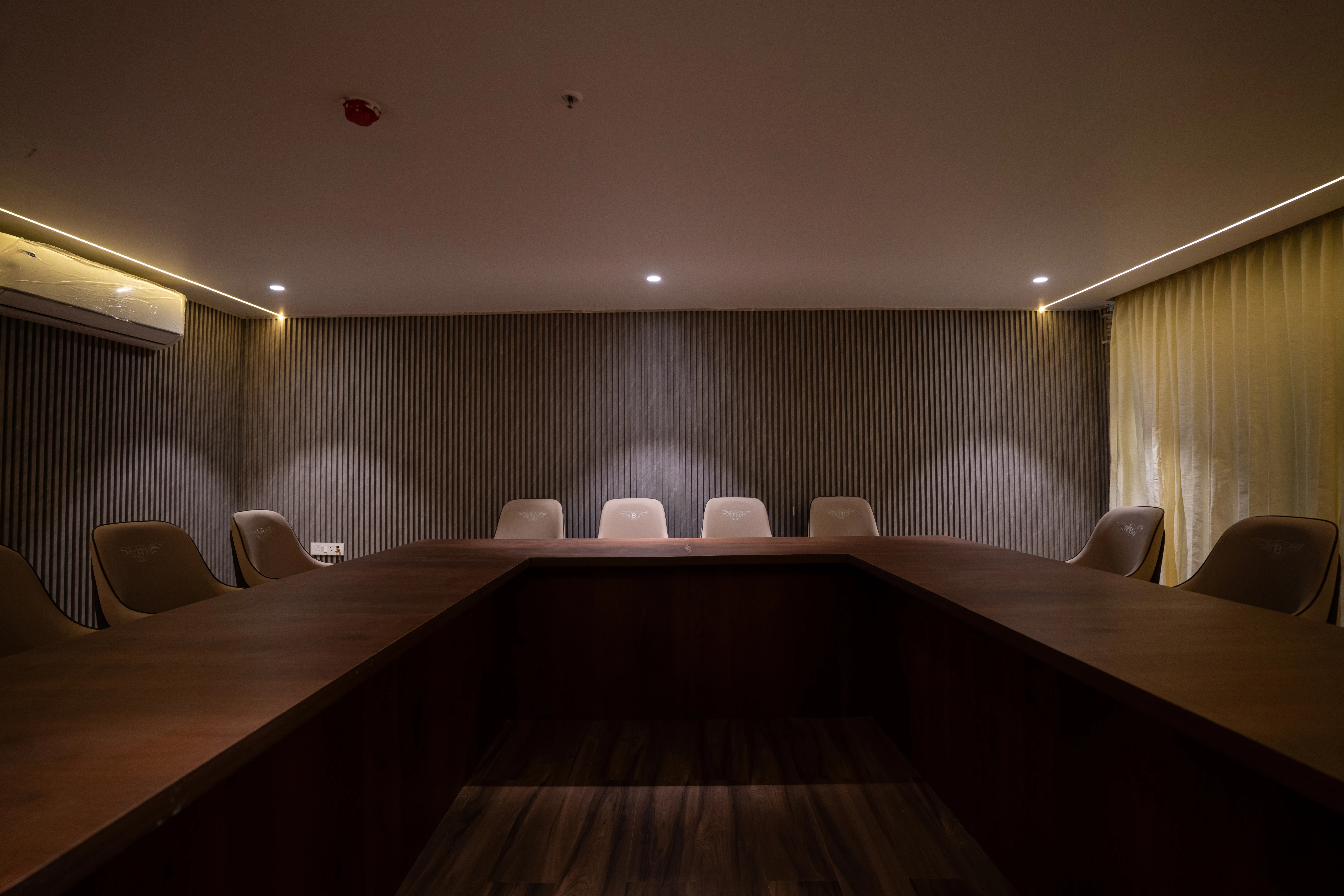 Networking event setup with casual seating, food counters, and professionals interacting