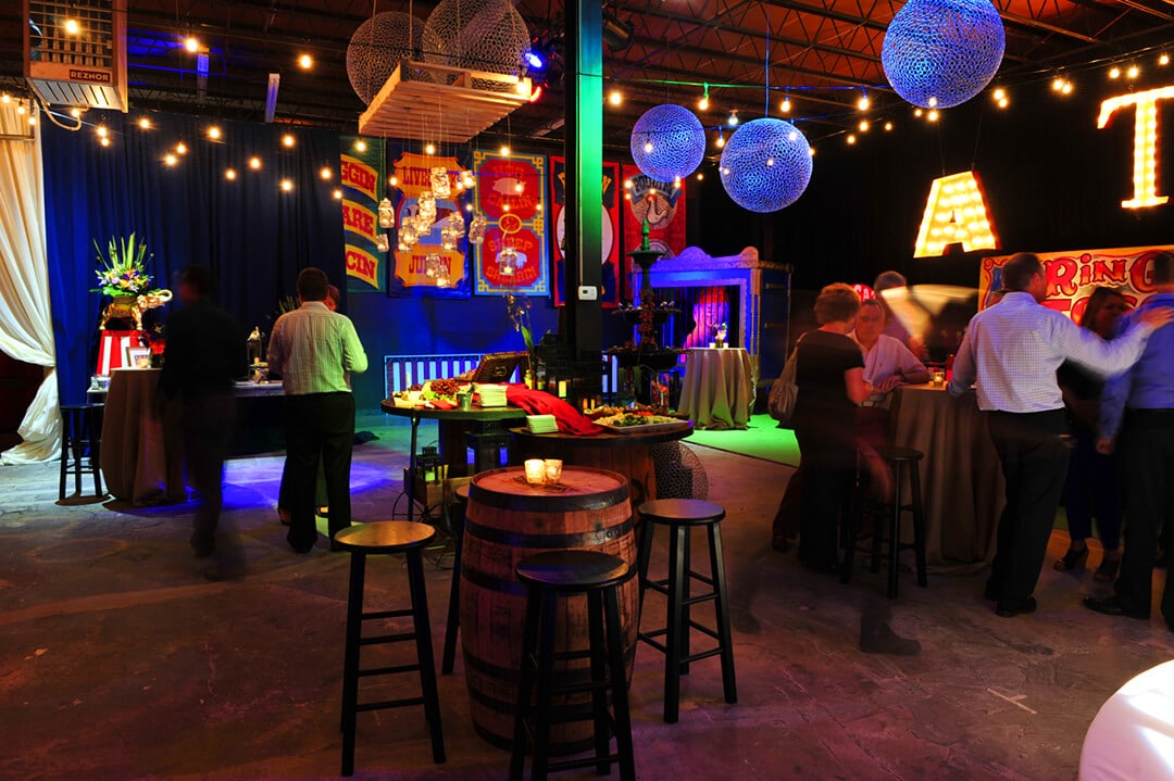 Themed party venue with colorful decorations, creative lighting, and guests enjoying the celebration