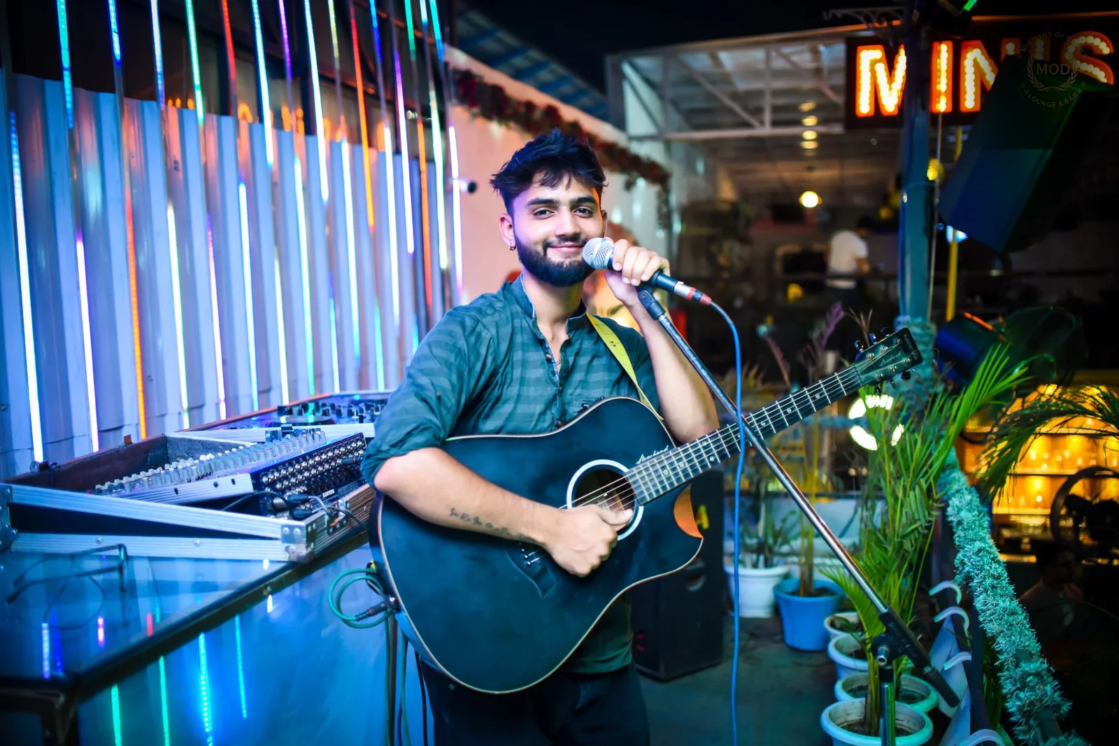 Open mic night with singer and guitar player on small cozy stage